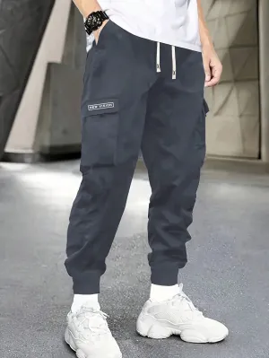 QA Fashionable Men Utility Pants, Casual And Sporty, With Simple Style, Letter Print, Drawstring Elastic Waist, Multiple Pockets, Comfortable, Versatile, Tapered Leg And Sweatpants