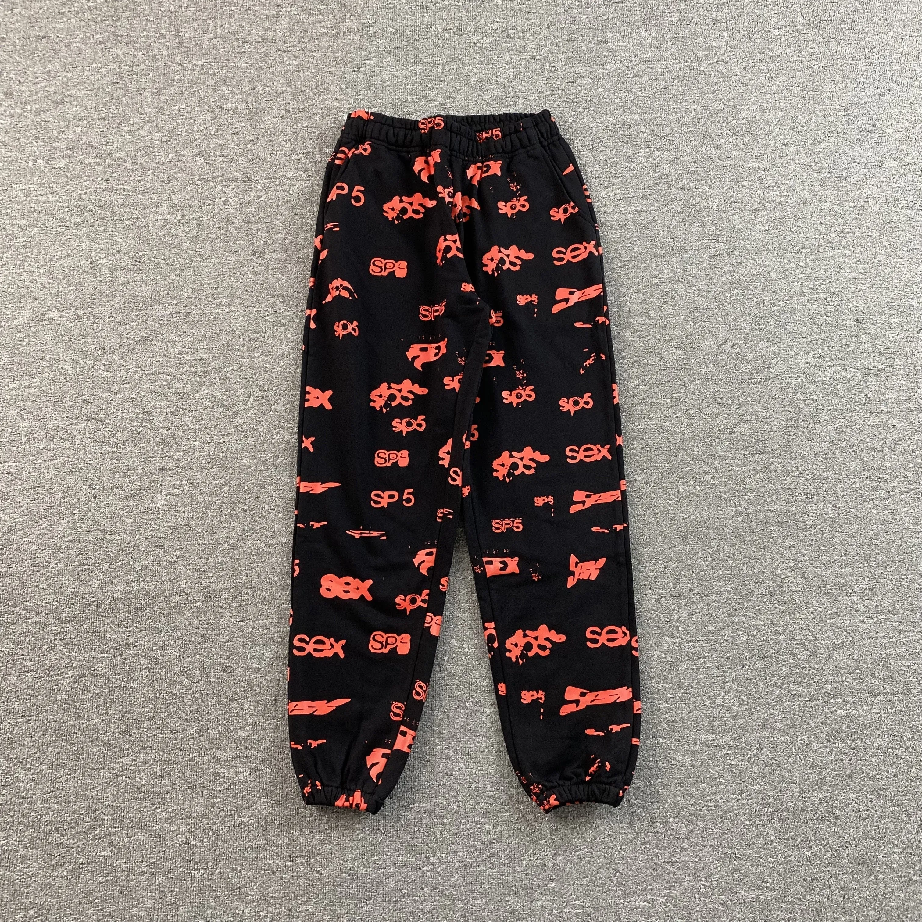 SP5DER SEX AOP SWEATPANTS BLACK